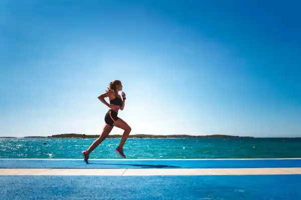 Woman running showing strong leg muscle Theale